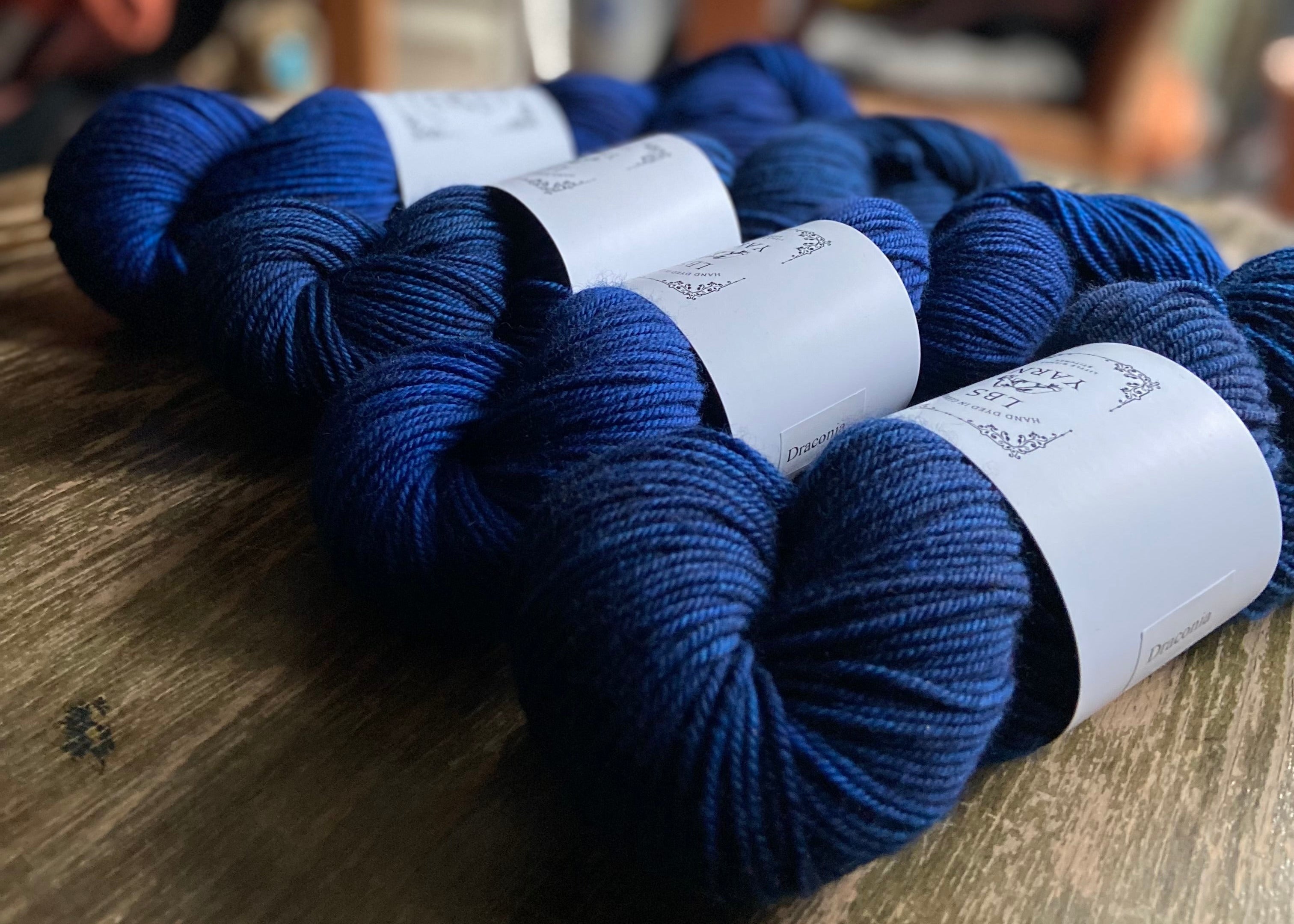 Blue yarn with on a wooden table surface